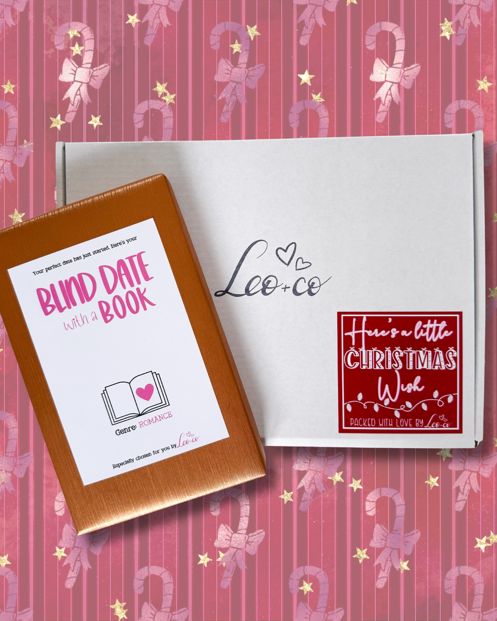 Christmas Blind Date With a Book gift box by Leo + Co, featuring a mystery book, cosy socks, shower steamer, Christmas wish bracelet, festive coaster, bookmark, self-heating eye mask and vegan gingerbread popcorn.
